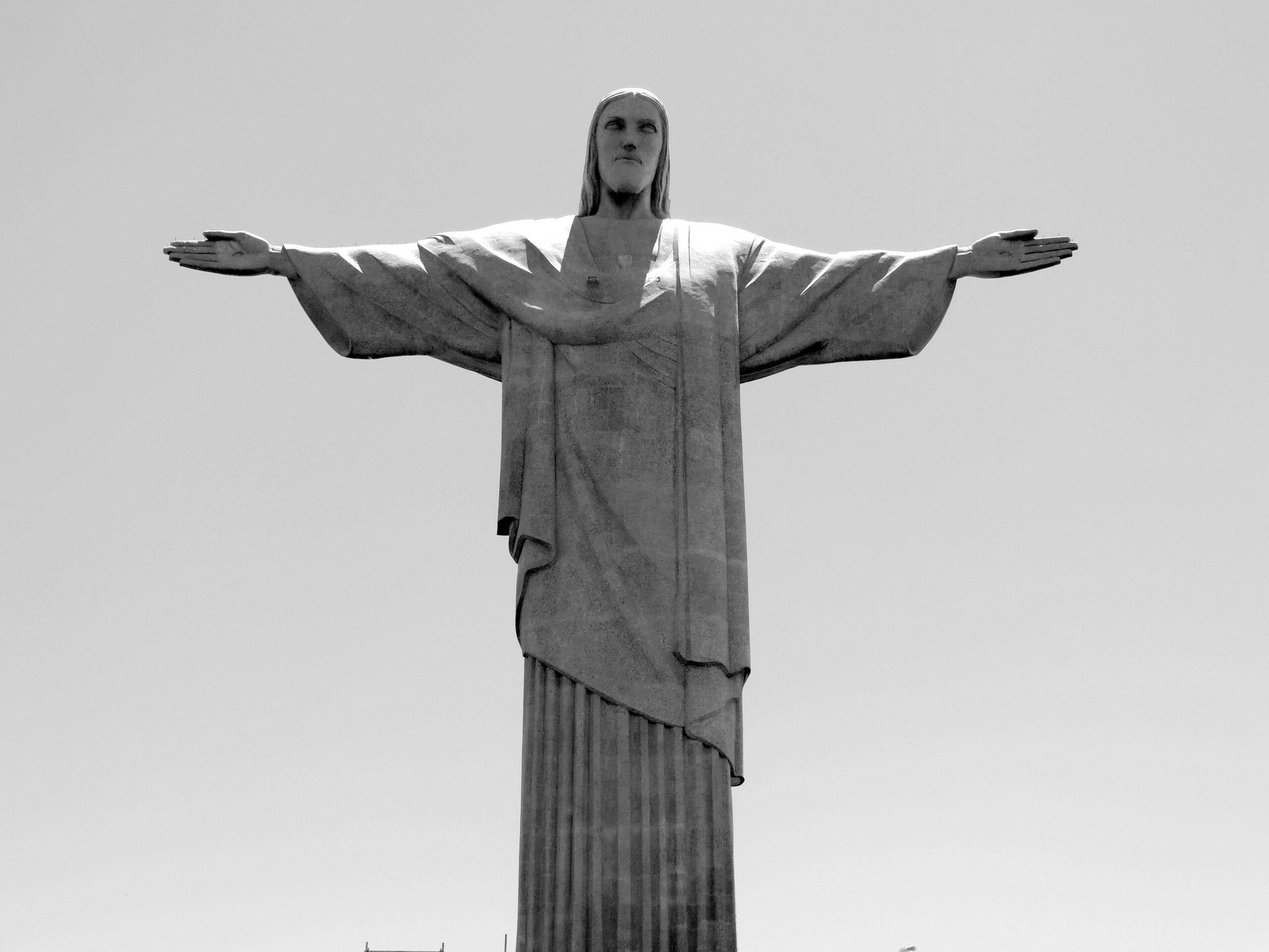 Black and white photo of the iconic Christ the Redeemer statue in Rio de Janeiro, Brazil.